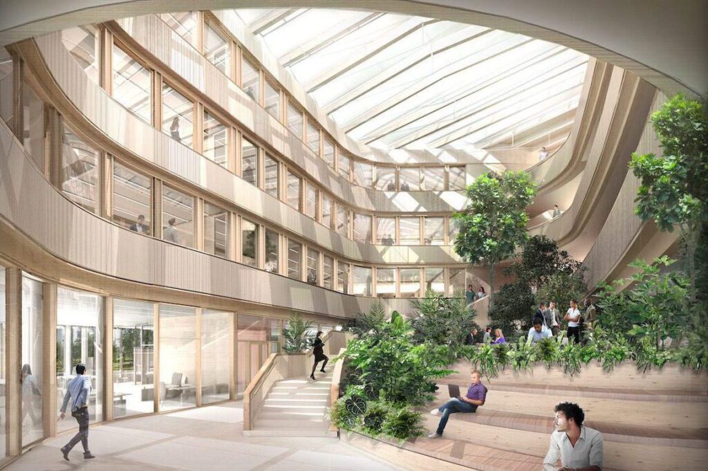 Biophilic office atrium at The Grove Schiphol featuring terraced greenery, integrated seating, natural light, and collaborative workplace environments.