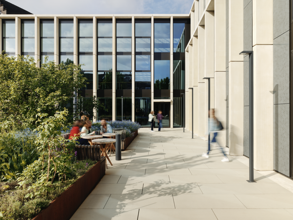 DSM-Firmenich Maastricht office façade with integrated landscape design, outdoor seating, and biodiverse planting in a sustainable campus setting