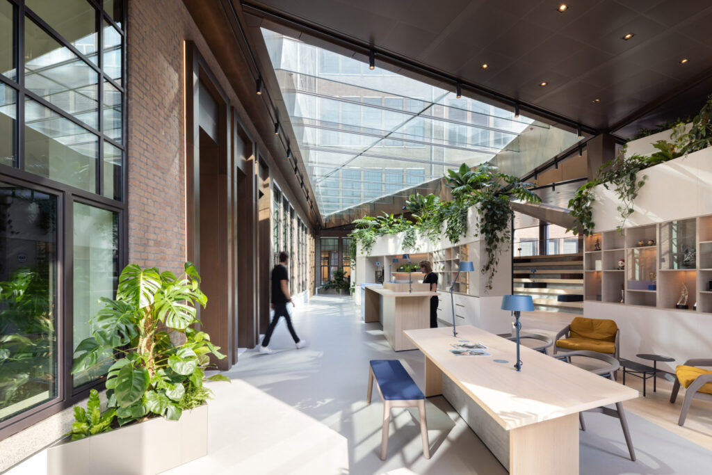 Biophilic office interior at Guerrilla Games Amsterdam with lush indoor planting, natural daylight, and collaborative workspace design by MOSS.