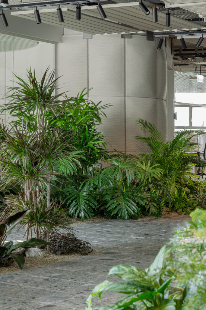 Dense indoor planting design at Holcim Switzerland creating a lush biophilic workspace