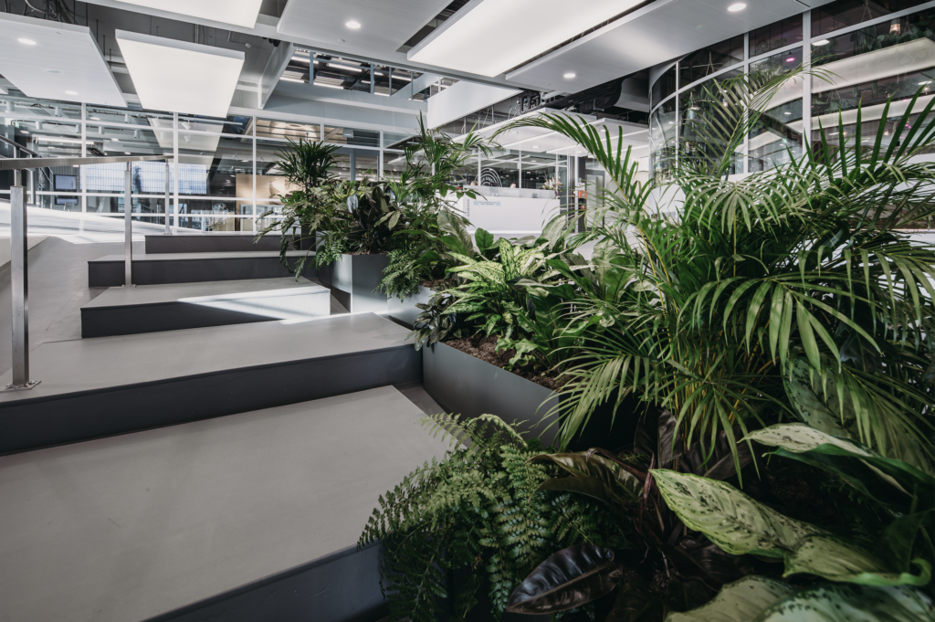 Biophilic staircase with integrated tropical planting at The Garage Amsterdam by MOSS