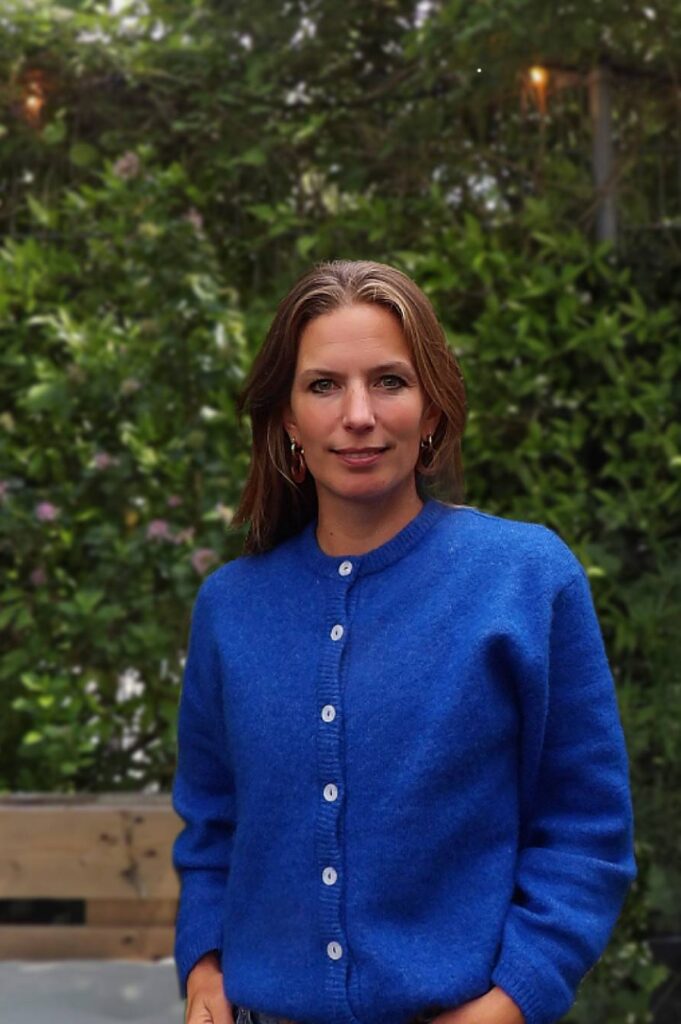 Portrait of Nina Sickenga, Co-Founder of MOSS, photographed in a lush green setting that reflects her commitment to biophilic design and sustainable urban environments.