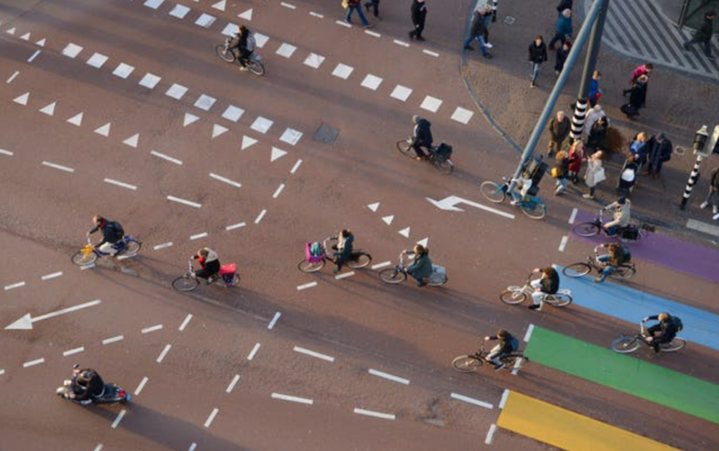 Busy urban intersection with cyclists and pedestrians illustrating high sensory stimulation in cities