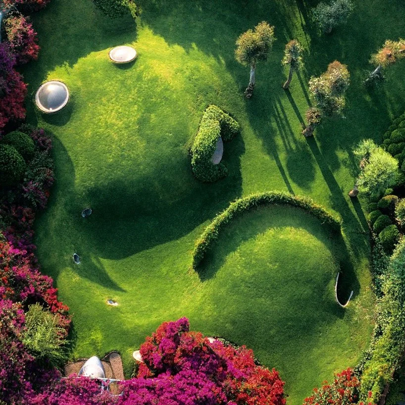 Organic landscape garden with sculpted greenery and curved forms inspired by natural patterns and biophilic design principles