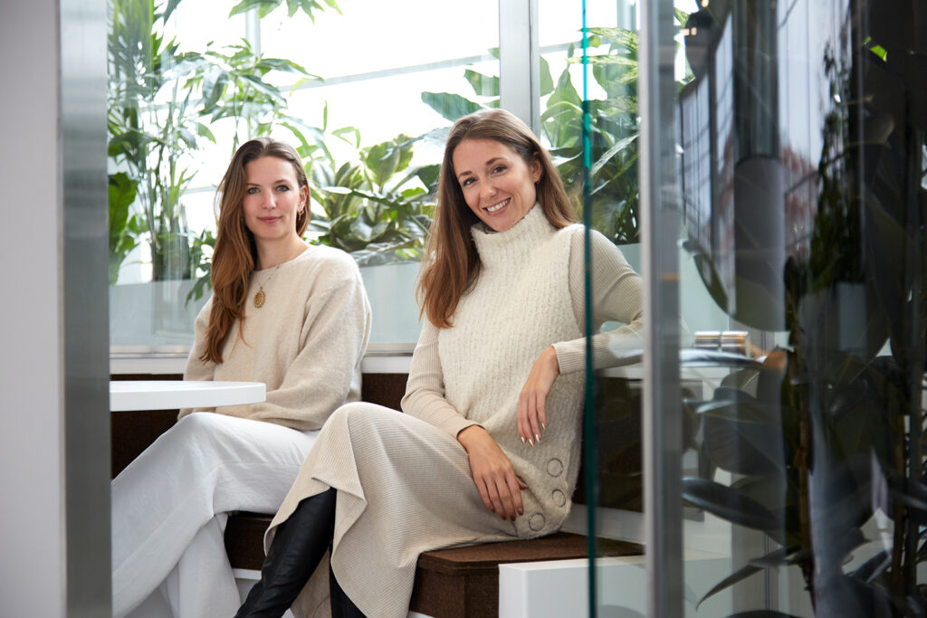 Portrait of MOSS founders in plant-filled interior highlighting biophilic design approach