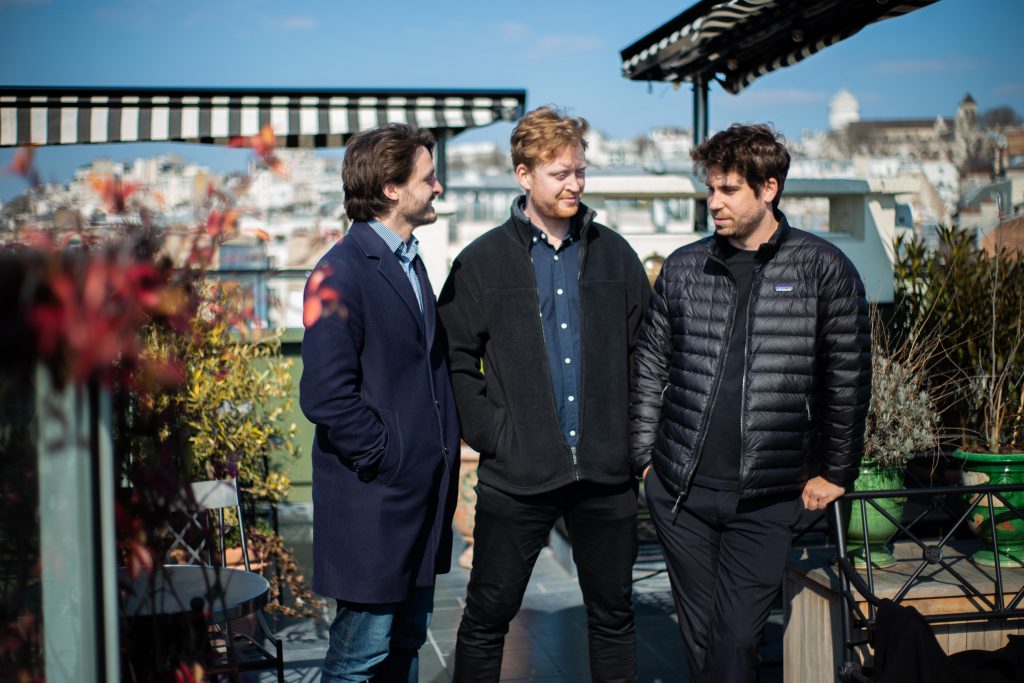 Team discussing urban greening and pollinator strategy on rooftop garden in city environment
