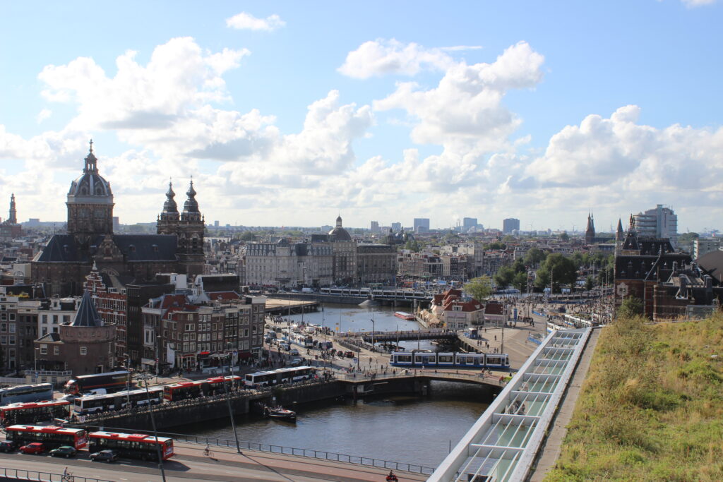 Bird’s-eye view of Amsterdam city center with canals, historic buildings, and dense urban layout