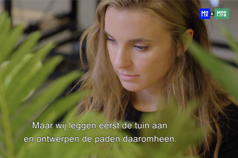 Designer working in a biophilic environment surrounded by plants, reflecting human-centered and nature-driven design process